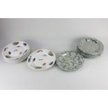 A set of eight Wedgwood green pottery plates, each decorated in silver lustre with all-over