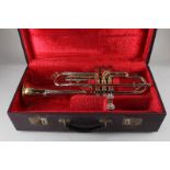 A brass trumpet marked Zenith MKII J R Lafluer London Foreign 527591, with two mouth pieces, in