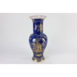 A Wiltshaw and Robinson Carlton Ware rouleau vase, decorated with gilt Chinoiserie scene, on blue
