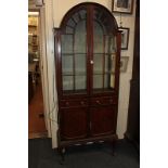 An early 20th century Queen Anne style mahogany display cabinet, with panel glazed dome top,