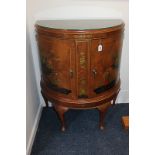 An early 20th century chinoiserie walnut demi-lune cabinet with twin doors decorated in relief