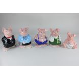 A set of five Wade Nat West Pig ceramic money banks, from Sir Nathaniel to baby, tallest 19cm high