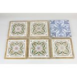 A set of five Continental glazed tiles, with floral and foliate decoration in green, purple and