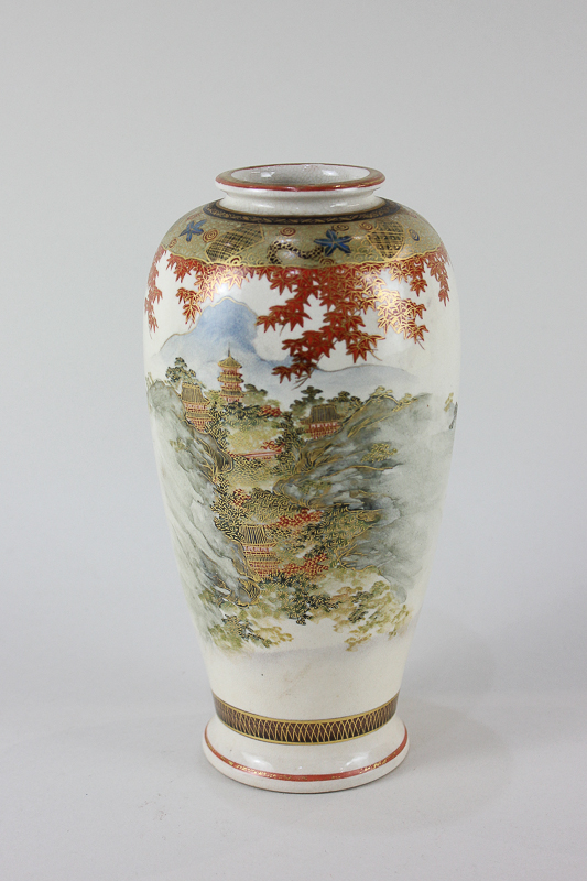 A Japanese Satsuma pottery vase, decorated with a scene of pagodas in a valley amongst trees,