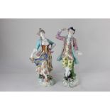 A pair of Continental porcelain figures of a lady and a gallant in dancing pose, with gilt