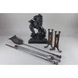 A Victorian black painted cast iron doorstop of a lion rampant, together with a pair of Arts and