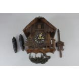 A West German cuckoo clock, of Alpine chalet form, the movement striking on a gong, and stamped ?