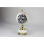 A Xavier of London onyx mantle clock, the circular dial with Roman numerals, on gilt metal dolphin