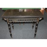 A Victorian ebonised rectangular card table with fold over green baize lined top, balustrade