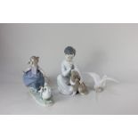 Three Lladro porcelain figures, a seated boy with a dog, a girl herding goose and goslings, and a