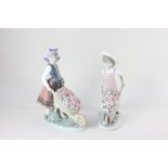 Two Lladro porcelain figures of a boy and a girl with wheelbarrows of flowers, tallest 26cm