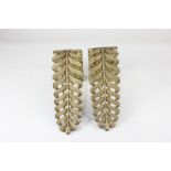 A pair of brass curtain hold backs cast with pierced palmettes