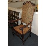 A Victorian scroll carved beech wood armchair with tapestry style upholstered back and cane seat, on