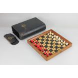 A Jaques & Son Patentees 'In Statu Quo' travelling chess set, the folding mahogany case with