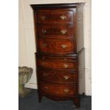 A walnut bow front chest on chest with dentil carved cornice above six crossbanded and inlaid