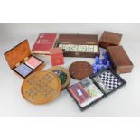 A Dominoes set within box with cribbage lid, a solitaire board with marbles, a travelling games set,