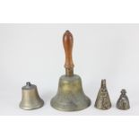 A brass 'Fiddian' school bell, a brass cow bell and two figural small bells