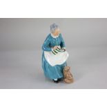 A Royal Doulton porcelain figure of an old lady with a cat, 'The Favourite' HN2249, 20cm high
