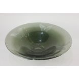 A green glass dish, of circular form, engraved with three butterflies, 32cm diameter