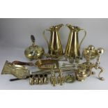 A large collection of brassware, including a pair of JS&S jugs, pair fire dogs and matching tools, a