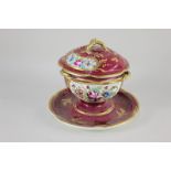 A small French porcelain pedestal bowl and cover on stand, decorated with floral panels on maroon
