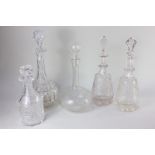 A collection of five various glass decanters, to include a globe and shaft decanter with engraved