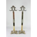 A pair of brass fireguards, with embossed floral scrolling design, (no tools) 60.5cm high
