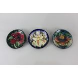 Three modern Moorcroft pottery circular dishes in the Anna Lily, Anemone and Windrush yellow iris