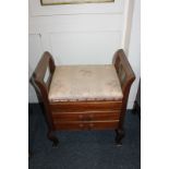 An early 20th century mahogany piano stool, with hinged box seat above two drawers with drop down