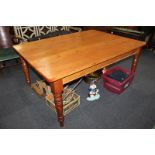 A pine rectangular kitchen table with rounded corners, on four turned baluster legs, 122cm by 168cm