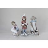Three Lladro porcelain figures of children, a 1993 Collectors Society girl with teddy bear, a boy