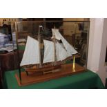 A wooden model of a ship, French Naval schooner Marseille 1764, inside a large glass case, case 63cm