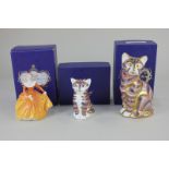 Two Royal Crown Derby porcelain paperweights modelled as cats, with gold stoppers, and associated