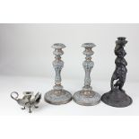 A pair of silver plated candlesticks, with embossed decoration, 26.5cm high, together with a cast