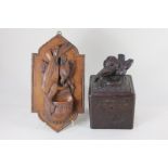 A Black Forest tea caddy, mounted with two carved birds on a nest, the body carved with foliate