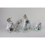 Three Lladro porcelain figures, a girl seated on a branch with two squirrels, a girl picking flowers