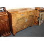 An Art Deco walnut sideboard, with rectangular top, and two drawers above two panel doors