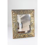 A continental style rectangular wall mirror, the pierced gilt frame with mask surmount and birds
