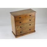 A miniature inlaid chest of drawers with knob handles, on plinth base, 30cm