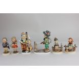Four Goebel Hummel figures of children, together with two larger similar Friedel Bavarian figures of