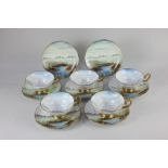 An English Crystal Bone China part teaset, each piece hand painted with a scene of a lake side