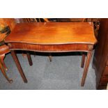 A 19th century mahogany side table, of serpentine shaped form, on square fluted legs, 87cm