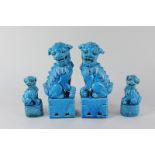 A pair of Chinese pottery Fo dogs in blue glaze, 20cm high (a/f) together with a pair of smaller