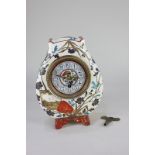 A French pottery mantle clock, the painted dial with Arabic numerals, the movement stamped JD, the