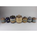 A collection of seven Royal Doulton, Doulton Lambeth, Slaters and silicone ware tobacco jars and