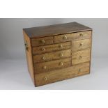 A burr walnut collectors cabinet, with an arrangement of eight drawers, 38.5cm wide