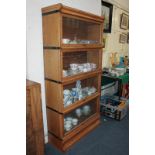 A Globe Wernicke style oak four-tier glazed bookcase on base with drawer, 86cm