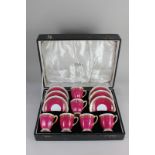 A Spode 'Ryde' pattern set of six bone china coffee cups and saucers, in maroon and white, with gilt