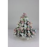 A Capodimonte porcelain centrepiece, heavily encrusted with pink roses, blue flowers and green