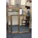 Three various modern gilt framed rectangular wall mirrors with scroll and foliate borders, largest